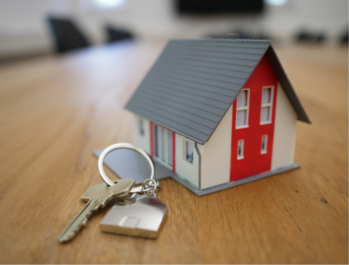 A model of a house with a set of keys